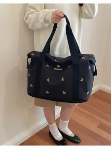 Black travel duffel bag with cute bow embroidery, large capacity fitness bag for women daily use.