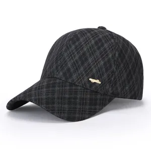 Detailed view of the winter women's plaid baseball cap with a stylish metal bow decor.
