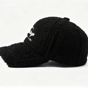 Black shearling baseball cap for women, cozy winter fleece hat with stylish curved brim.