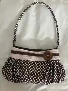 Retro polka dot underarm bag with pleated cloud design and cute wooden button detail.