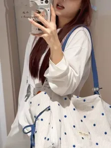 Summer blue polka dot shoulder tote bag detail, casual commute lightweight fashion design.