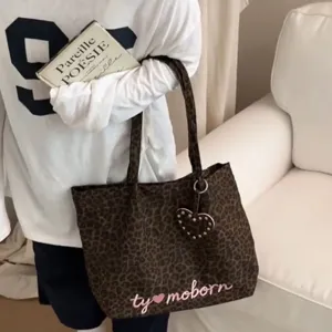 Casual leopard print tote bag with heart charm, large capacity shoulder handbag for women.