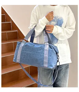 Large capacity travel duffel bag with stylish blue leopard print and shiny straps for gym.