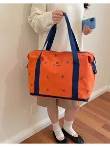 Large capacity travel duffel bag with cute bow embroidery, stylish casual luggage bag.