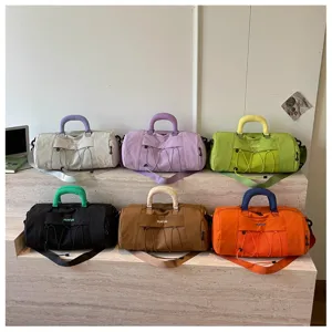 Multi-color travel fitness gym duffel bag with wet dry separation and adjustable strap display.
