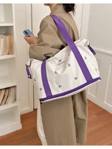 Large capacity travel duffel bag for women, stylish purple bow embroidery shoulder gym bag.