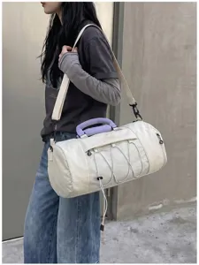 Detail view of large capacity cylindrical fitness duffel bag with dry wet separation pocket.