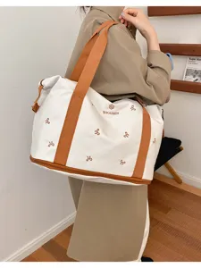 Large capacity canvas travel duffel bag for women, casual commuter shoulder luggage handbag.
