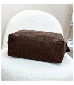 Leopard print travel bag detail shot, brown large capacity luggage and gym bag texture display.