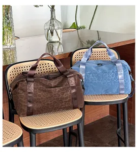 Detailed shot of large capacity leopard duffel bag placed on chair, ideal for travel use.