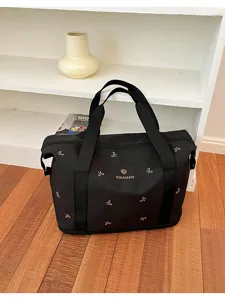 Black large capacity travel duffel bag with cute bow patterns for gym, fitness and weekend trips.