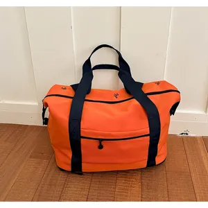 Orange large capacity travel duffel bag with black straps and stylish design for fitness.
