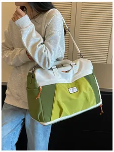 Große Reisetasche mit Farbdesign, Schultergurt und praktischen Tragegriffen ideal.
