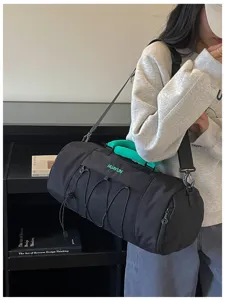 Details of black waterproof fitness duffel bag, large capacity travel gym bag with green handle.