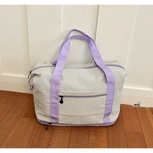 Large capacity casual travel duffel bag with purple handles and durable lightweight fabric.
