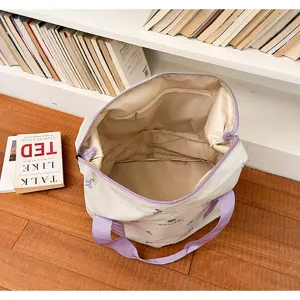 Large capacity canvas travel duffel bag with purple handles for gym and weekend trips.