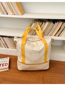 Canvas travel duffel bag with yellow straps and cute bow embroidery, large capacity storage.