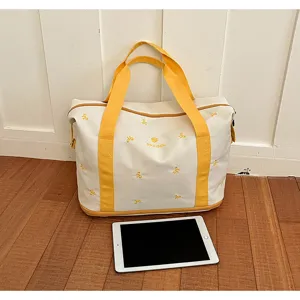 Large capacity canvas travel duffel bag with yellow handles and cute bow embroidery design.