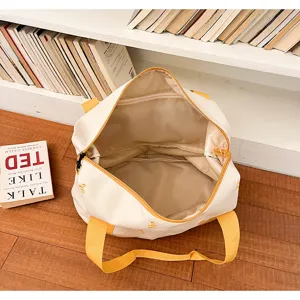 Close-up detail of the beige canvas travel duffel bag showing durable yellow straps and interior.