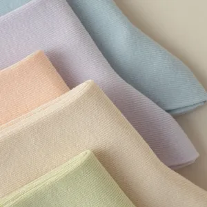 Close-up of pastel ribbed combed cotton socks fabric, soft texture, spring summer detail.