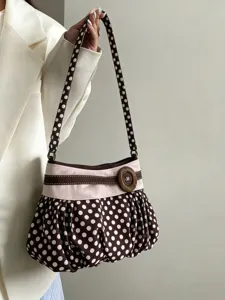 Brown white polka dot underarm shoulder bag pleated cloud purse wooden button detail close up