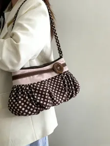 Retro polka dot shoulder bag with pleated cloud design and wooden button accent for women.