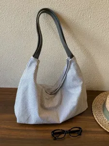 Blue and white striped canvas shoulder bag detail, casual lazy style underarm bag.
