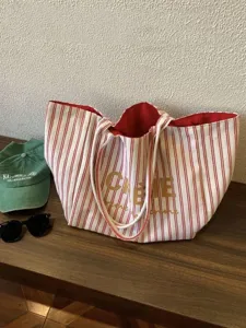 Detailed view of the French style striped canvas tote bag with red and white pattern.
