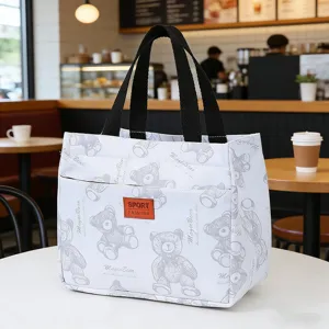 Japanese insulated lunch bag with cute bear print and sturdy handles for daily work.