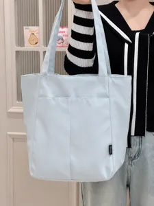 Light blue minimalist canvas tote bag detail, casual commuter style with large capacity.