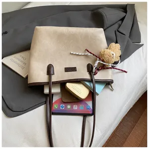 Minimalist beige PU leather tote bag with brown handles, stylish commuter shoulder bag for women.