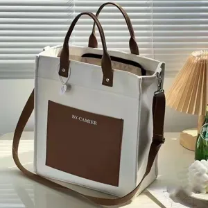 Canvas tote bag with brown handles and shoulder strap, stylish daily casual handbag.