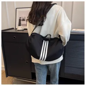Casual black shoulder crossbody bag for women, stylish fabric travel daypack with stripes.