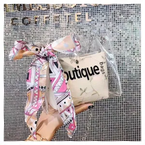 Clear PVC jelly crossbody bag with colorful printed ribbon bow and metal chain strap for women.
