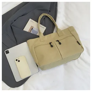 Casual canvas tote bag with front zipper pockets, stylish commuter handbag for students.