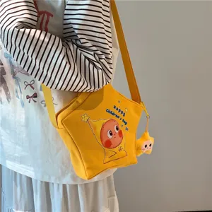 Canvas star shaped crossbody bag with cute cartoon print and shoulder strap for daily use.