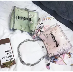 Candy color clear PVC jelly shoulder bag with floral embroidery and cute chain strap.