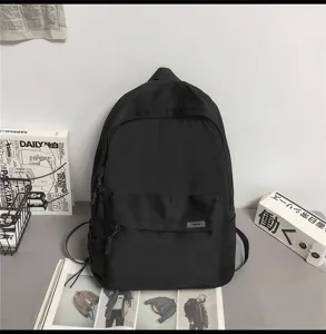 Minimalist black backpack detail shot, large capacity casual daily school bag for students and trav.