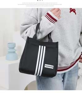 Casual black canvas tote bag with white stripes and fashion tag for daily commuting and office work