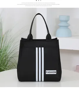 Black canvas tote bag with white stripes and fashion patch, ideal for daily commute and lunch.