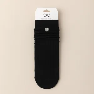 Black cotton slouch socks with embroidered silver heart design, perfect cute hosiery main view.