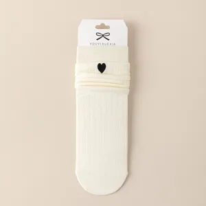 Cute Japanese style women mid-calf slouch socks with black embroidered heart. Soft cotton knit.