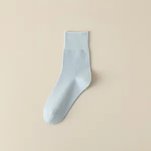 Minimalist solid color mid-tube combed cotton women socks in light blue breathable design.