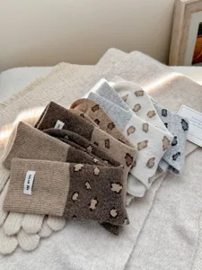 Cozy women's wool socks with stylish color block design and retro leopard print look.
