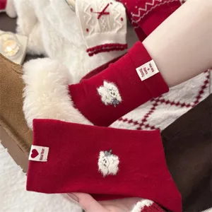 Cozy winter red woolen socks with cute fluffy animal embroidery, thick warm festive hosiery.