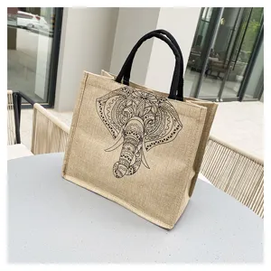 Detailed view of casual cotton linen tote bag featuring ethnic elephant print and sturdy handles.