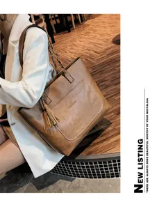 Detailed view of the stylish PU leather tote bag with tassel accent and shoulder strap design.