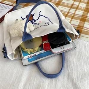 Cute canvas tote bag capacity detail showing inner space with daily items, student style.