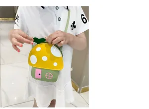 Cute cartoon mushroom house cross-body bag for kids, playful design with bright yellow cap.