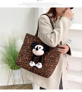 Leopard print canvas tote bag with cute cartoon mouse plush toy, stylish shoulder bag for women.